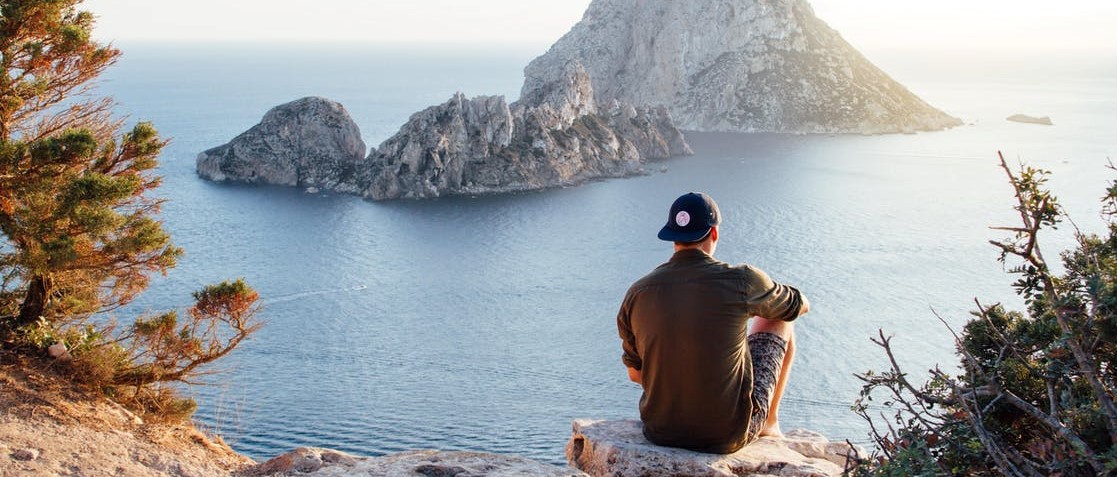 A man sitting near lake