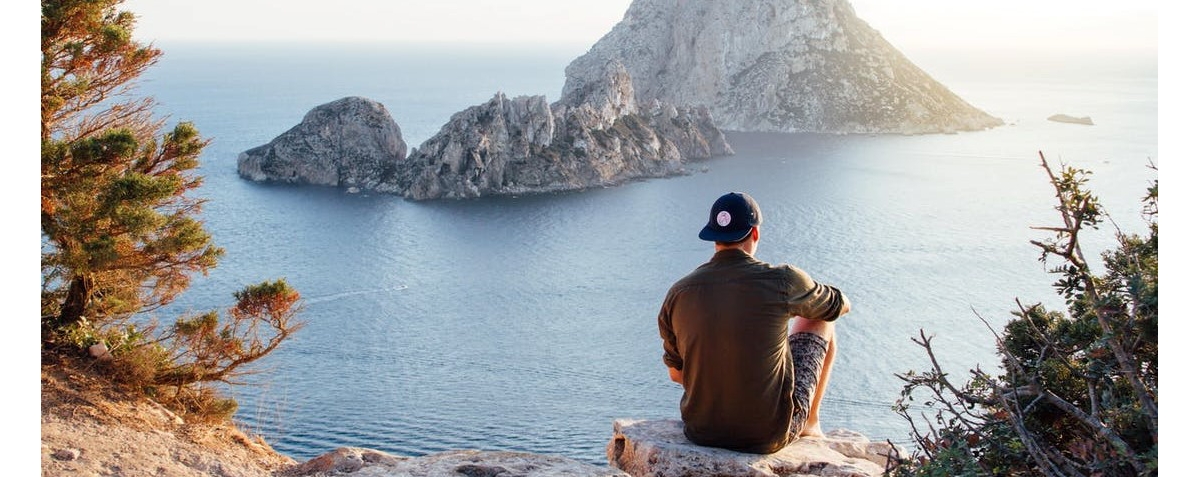 A man sitting near lake