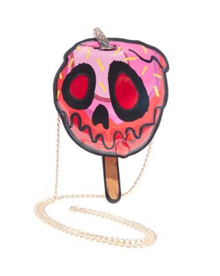 This spooky candy apple shaped bag will capture a hardcore vibe with a skull design over this sweet treat. This crossbody is the perfect blend of soft and hard. Candy apple shape Skull design over a candy apple design Zippered closure Chain strap Fully lined interior Manmade materials Gold hardware 53" strap 7"H x 6.5"W x 3"D
