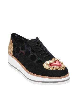 The WINNIE is a quirky platform lace up that will take your look to the next level. Its sheer upper is decorated with glitter, jewels, and hearts that creates a luxurious look. Lace up platform oxford sneaker Metallic/red heart embellishment on toe Gold glitter detail on heel Mesh/microfiber upper material Manmade lining 0.75" platform 1.75" heel height