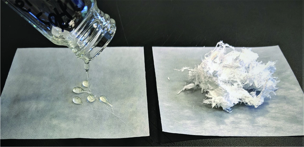 A photo of viscous liquid drops and fluffy white plastic pieces.