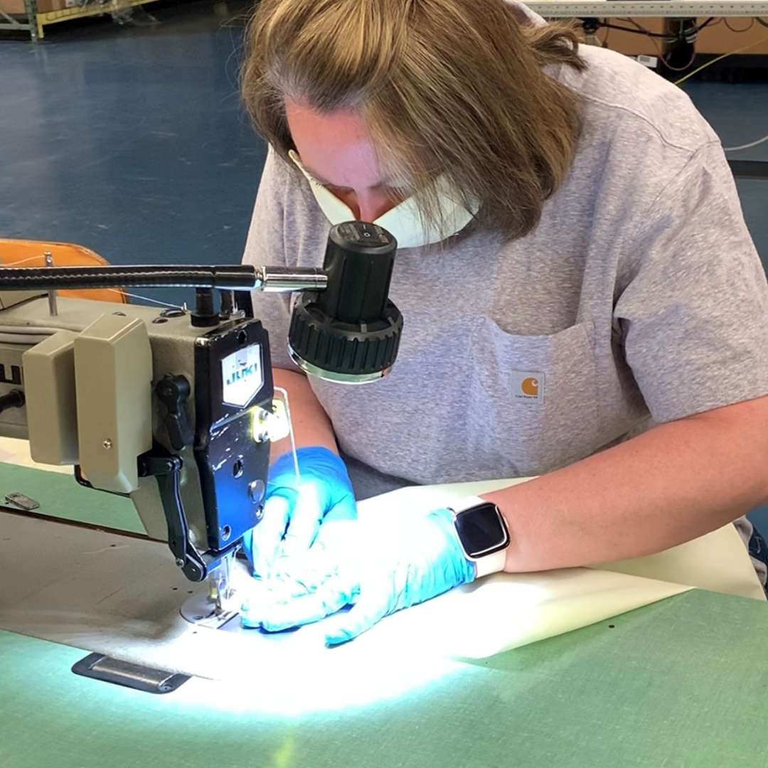 A woman sewing a surgical mask