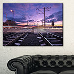 Designart Rail Crossing With Blurred Car Lights Canvas Art