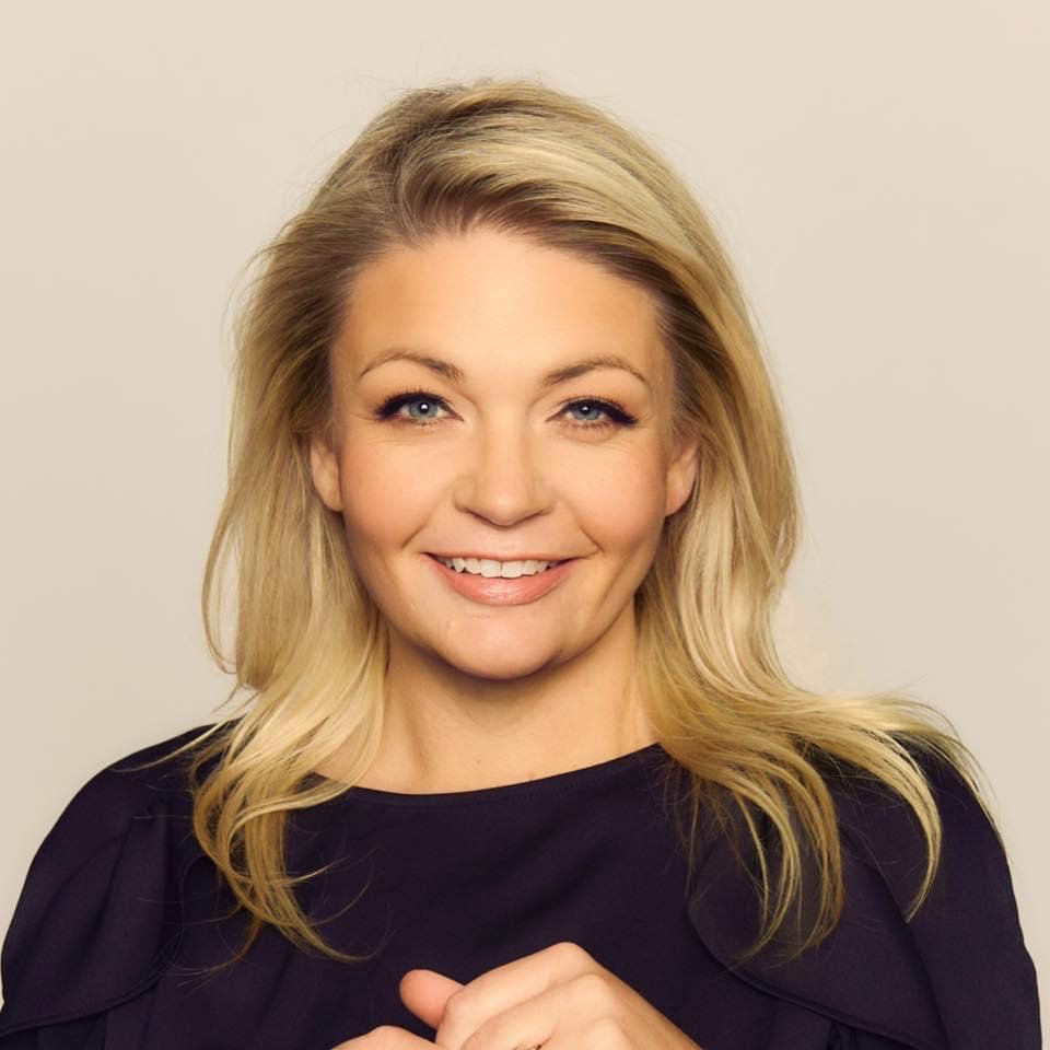 Headshot of Laura Cooksey smiling, with a neutral background