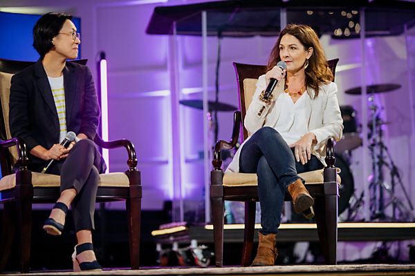 two ladies speaking on stage