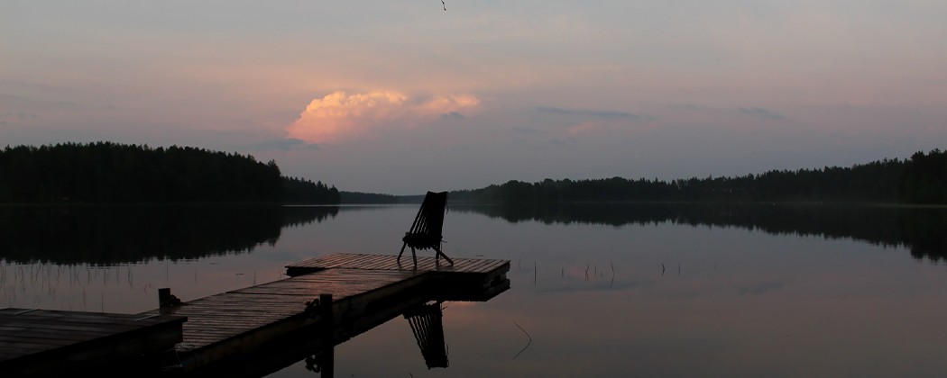 Lone chair on a dock at lake