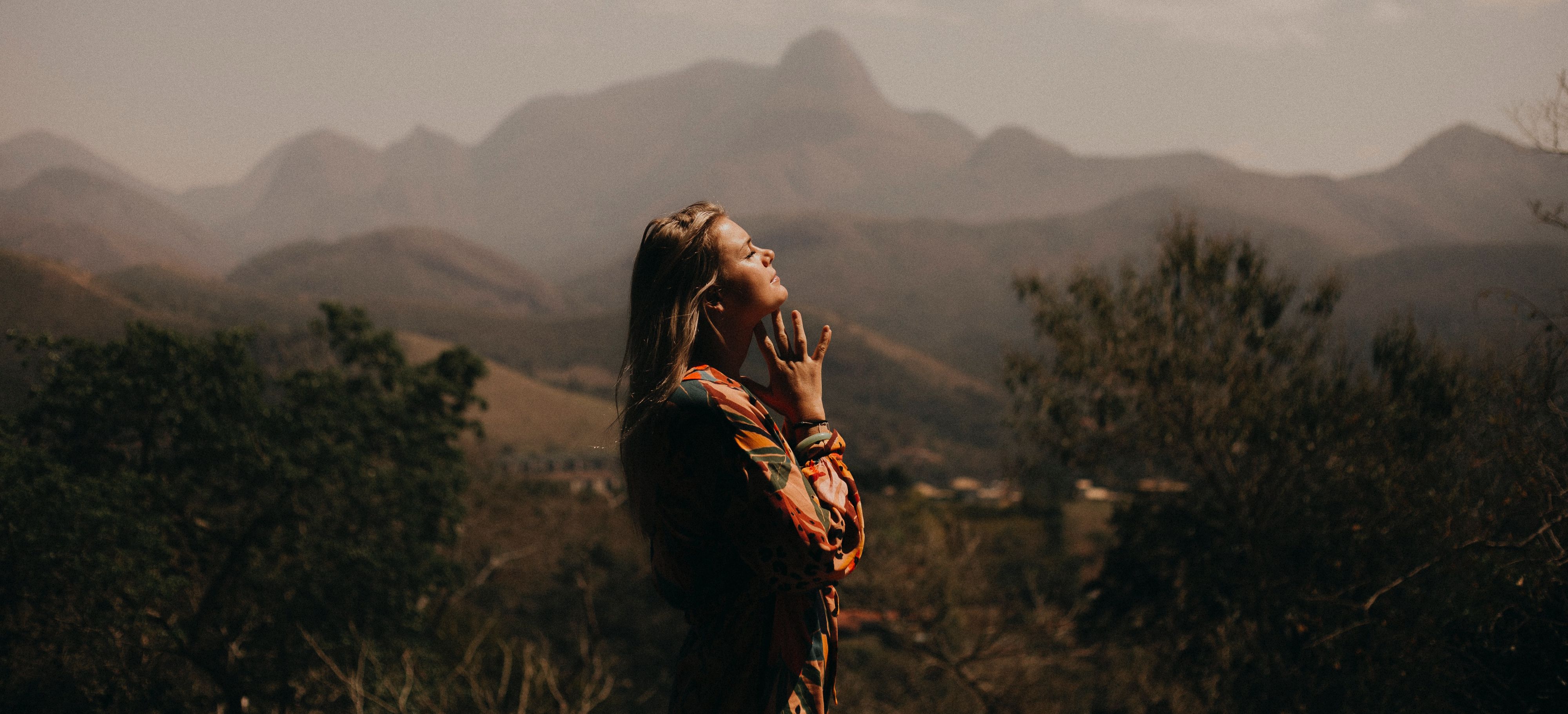 Girl praying in the mountains