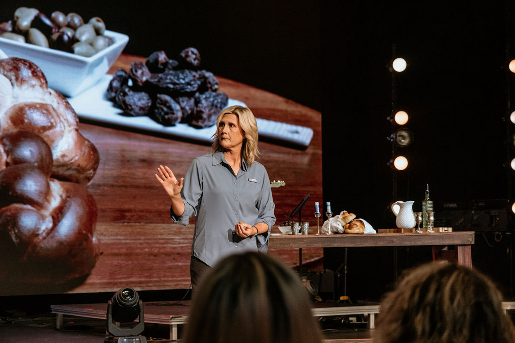 Kristi McLelland teaching with food on table in background