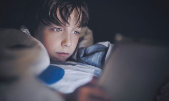 Kid watching tablet before bed.