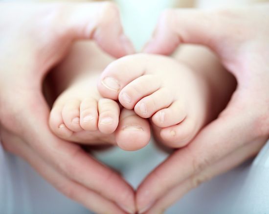 grace based parenting, mom and dad holding baby 