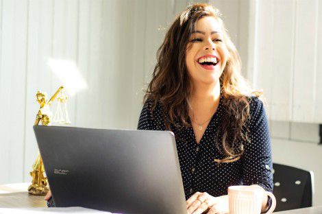 woman laughing on computer