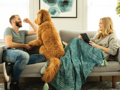 family with dog on couch