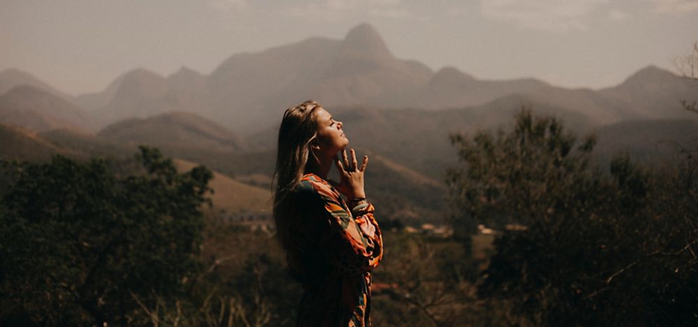 https://s7d9.scene7.com/is/image/LifeWayChristianResources/woman-praying-by-mountains?wid=1000&op_usm=2,.5,6,0