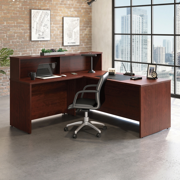 Elegant L-shaped reception desk by National Business Furniture with wood finish in a sleek modern office setup. Shop now!