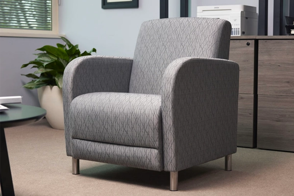 USA-made Parkside Collection guest chair in gray patterned fabric, placed in a modern office.
