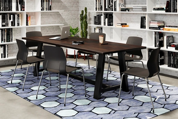 USA-made Urban Loft Espresso/Black Frame table in a modern conference room with white shelves, black chairsand a patterned rug.