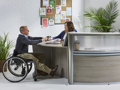 Wheelchair accessible reception area with visitor meeting receptionist