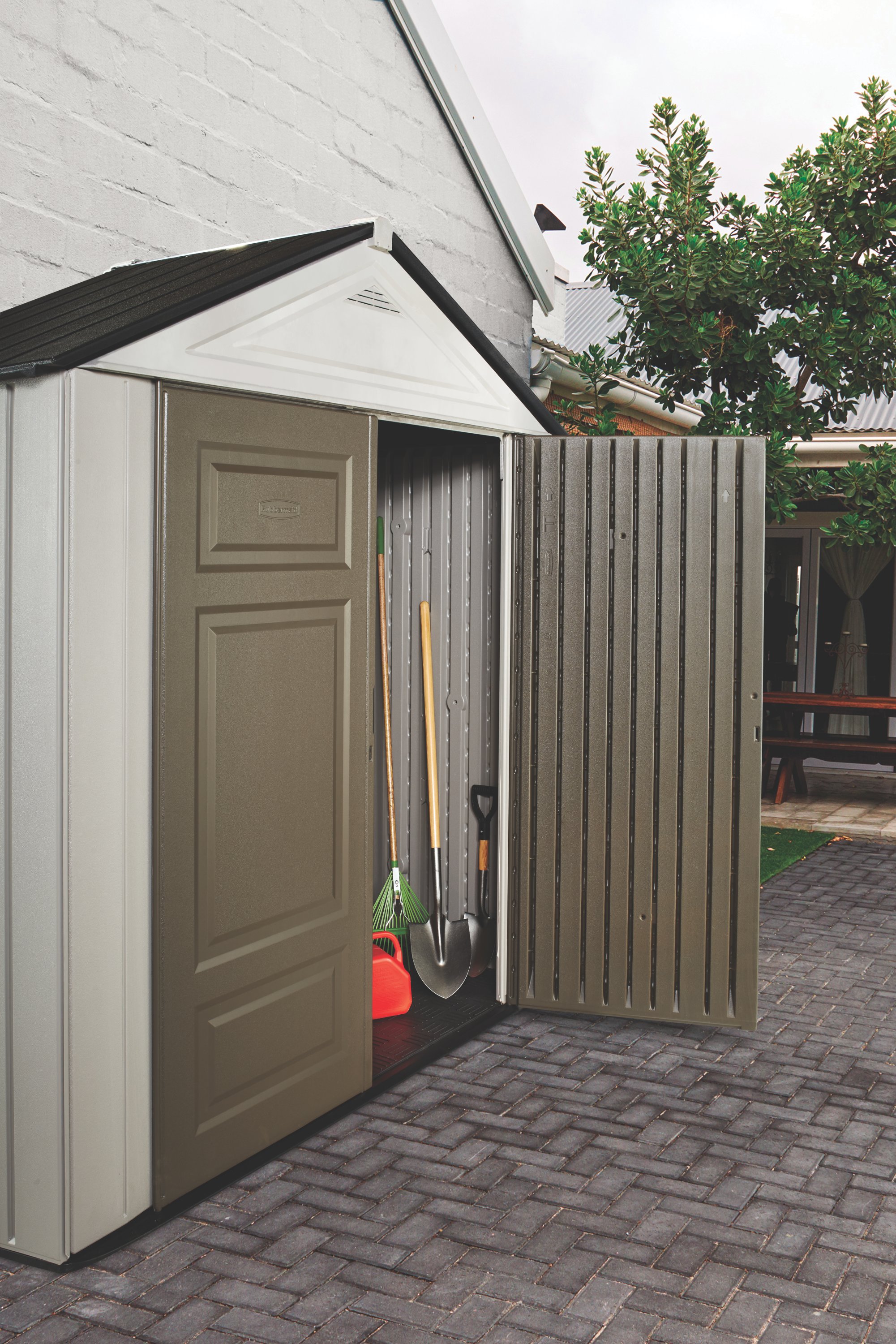 https://s7d9.scene7.com/is/image/NewellRubbermaid/2035897-ccs-outdoor-sheds-7x3-big-max-jr-canteen-brown-backyard-propped-right-door-open-close-up-into-shed-lifestyle-1