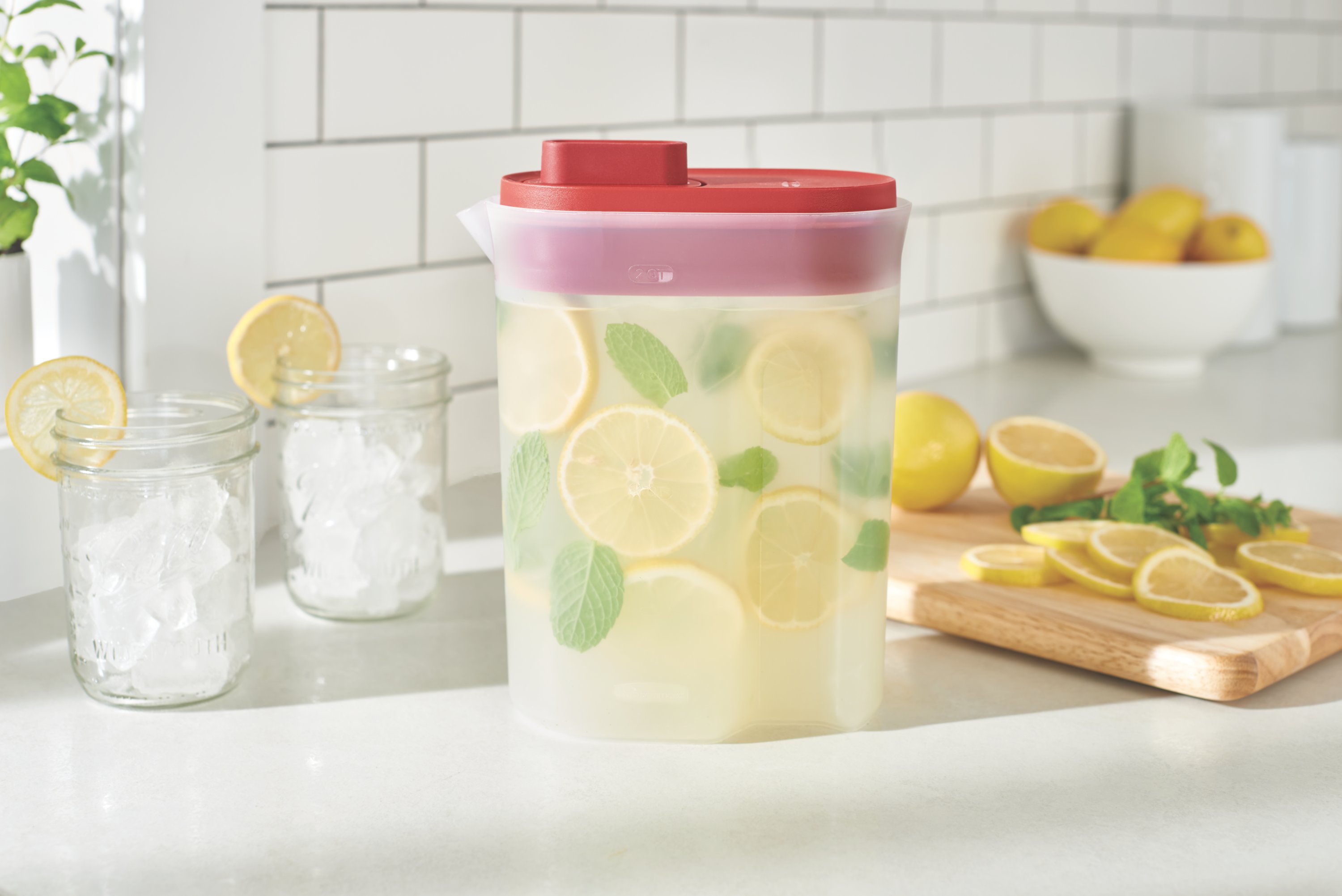 https://s7d9.scene7.com/is/image/NewellRubbermaid/2122589-rubbermaid-food-storage-ss-pitcher-premium-lid-2qt-red-kitchen-with-food-lifestyle-1