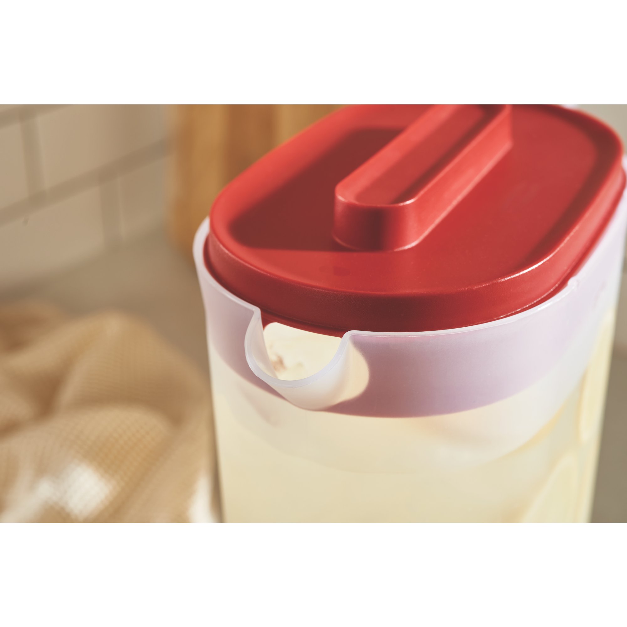 https://s7d9.scene7.com/is/image/NewellRubbermaid/2122602-rubbermaid-food-storage-compact-pitcher-1g-red-kitchen-with-food-lifestyle-4?wid=2000&hei=2000