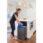 woman in kitchen taking recycling out of dual stream step-on garbage can image number 7