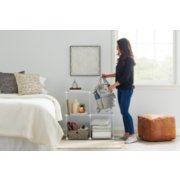 woman standing with freestanding storage bins in room image number 6