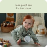 Baby holding Nuk sippy cup with leak proof seal for less mess image number 5