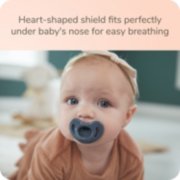 Baby with Nuk pacifier with heart shaped shield that fits perfectly under baby's nose for easy breathing image number 5