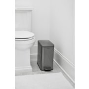slim rectangular trash can in bathroom next to toilet image number 5