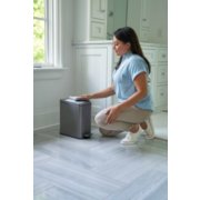 woman wiping clean small stainless steel garbage can image number 7