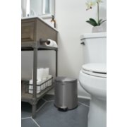 small metal circular trash can in bathroom next to sink and toilet image number 5