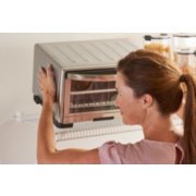 Woman placing toaster over on top of Rubbermaid organizing tight mesh shelf image number 7