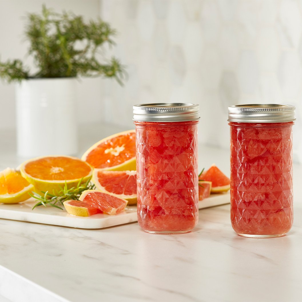 Canned fruit preservatives in mason jars on kitchen counter