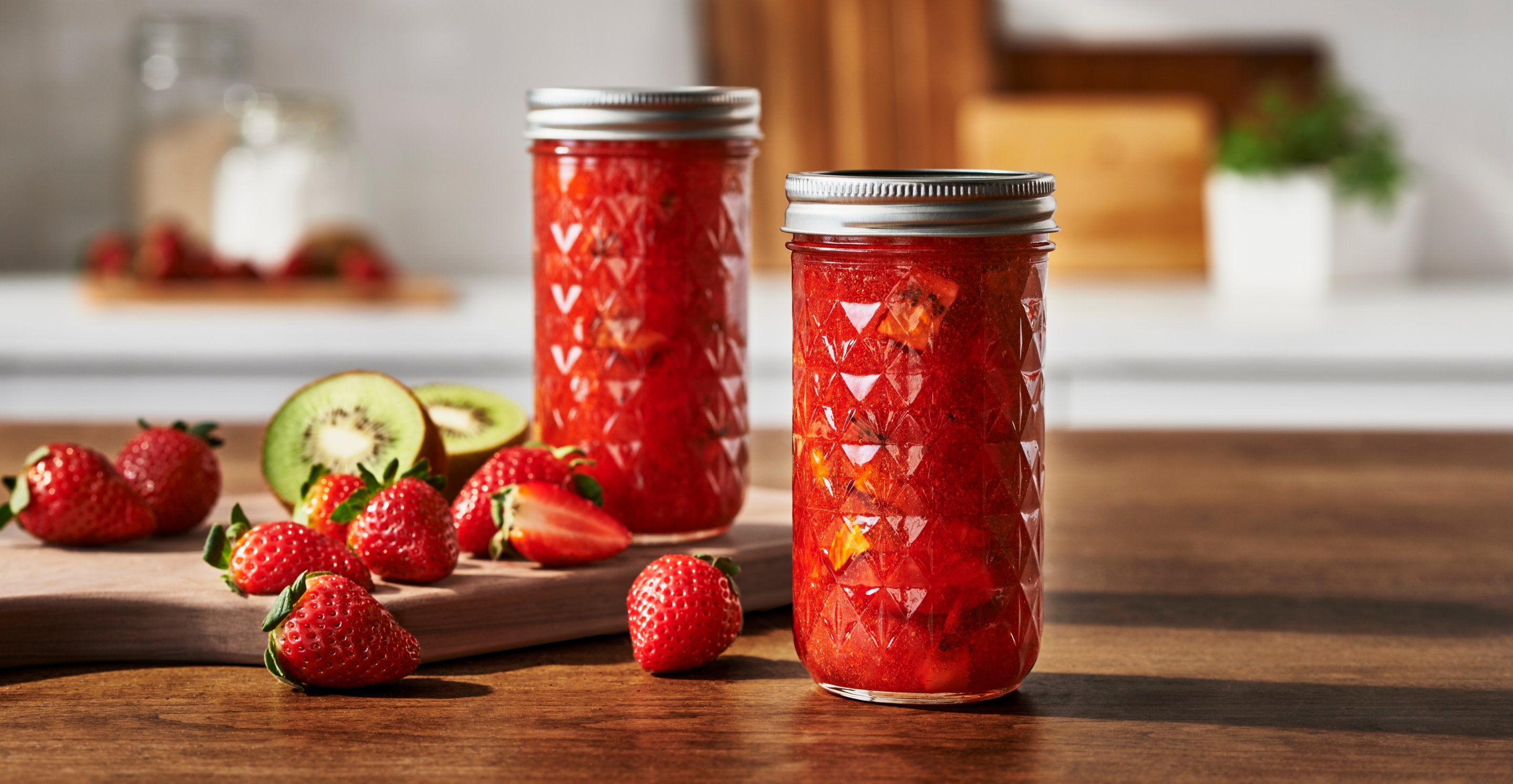 Canned fruit preservatives in mason jars on table in kitchen