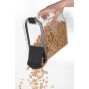 a clear food storage bin with opened lid pouring food image number 5