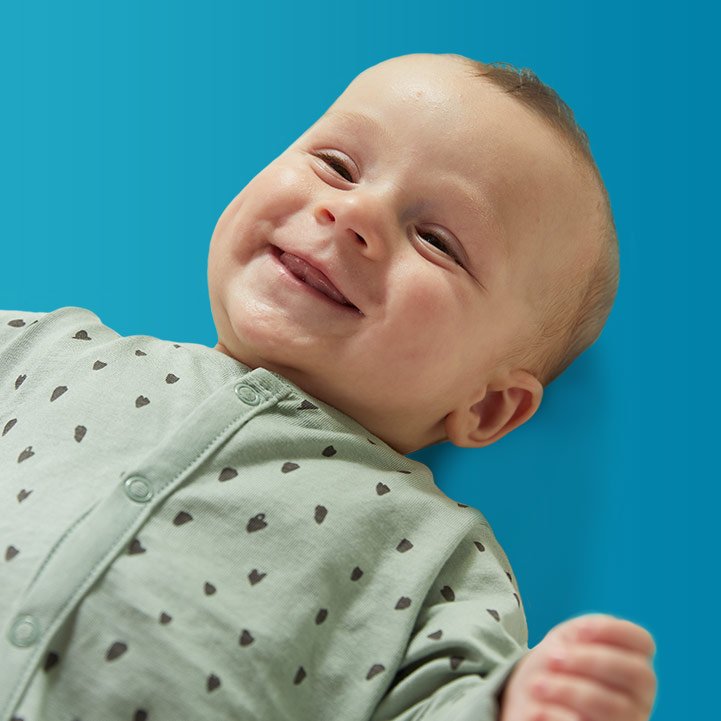 baby smiling on back