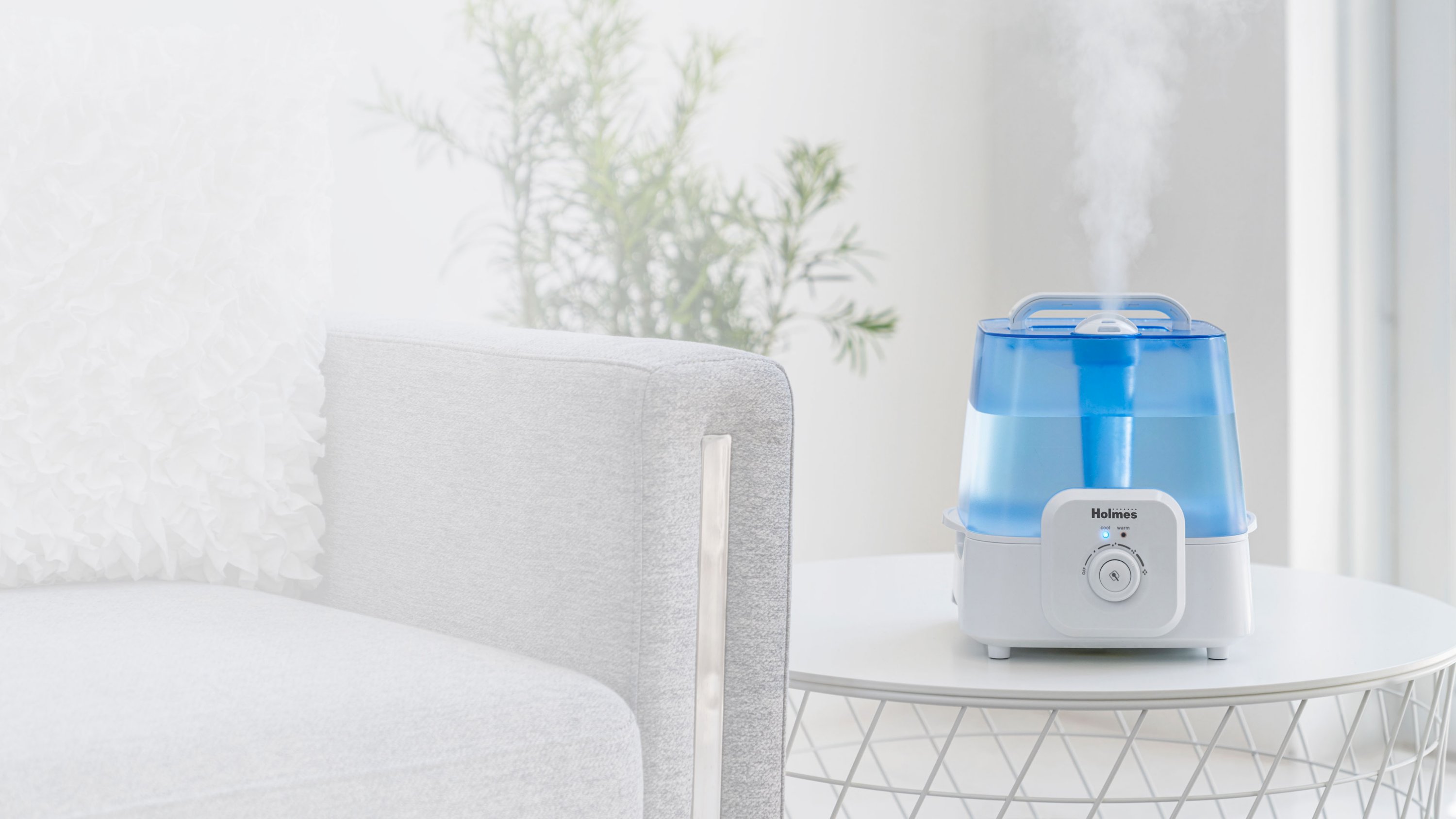 humidifier with cool and warm settings next to couch