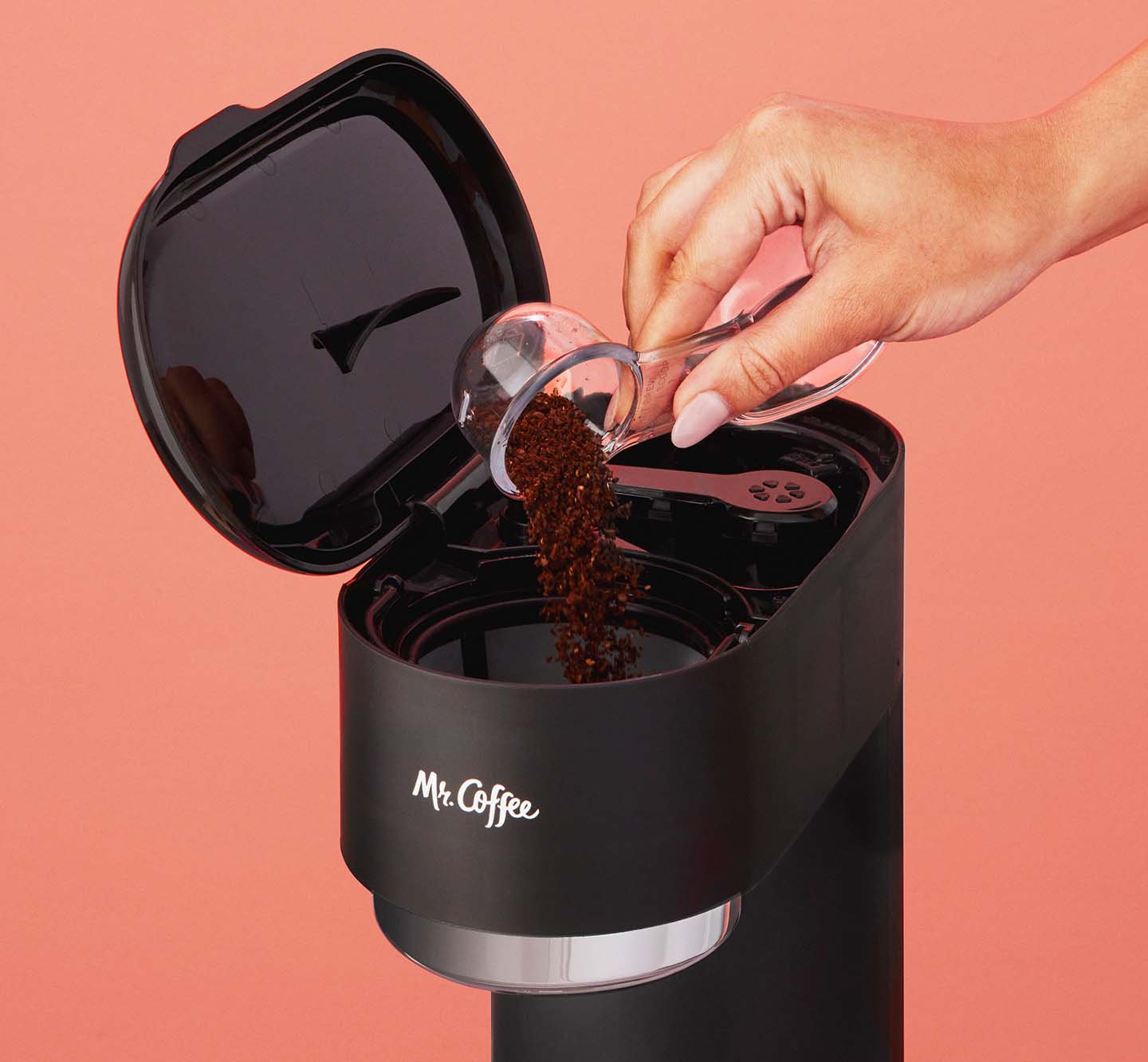 Putting coffee grounds into a coffeemaker