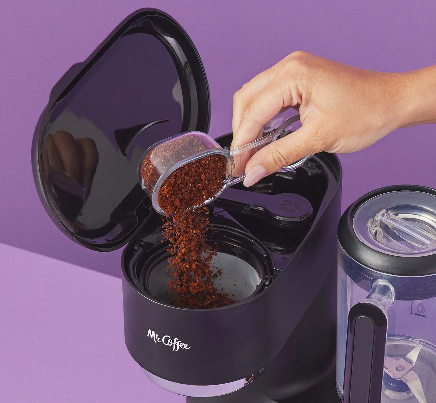 Putting coffee grounds into a coffeemaker