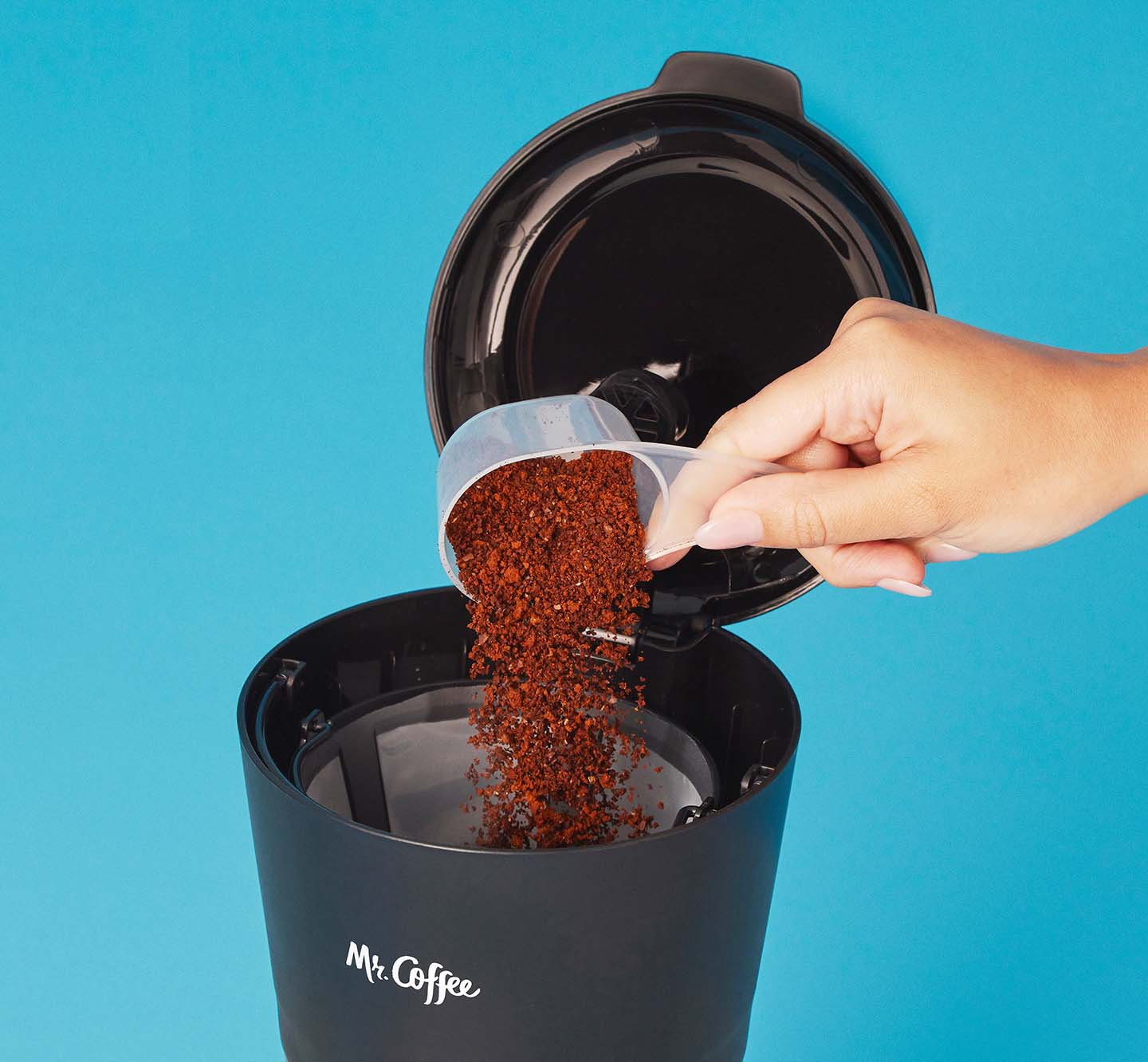 Putting coffee grounds into a coffeemaker