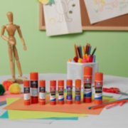 Assortment of Elmer's glue sticks on crafts table image number 3