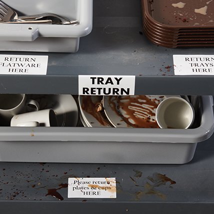 Soiled labels at a restaurant tray return area.