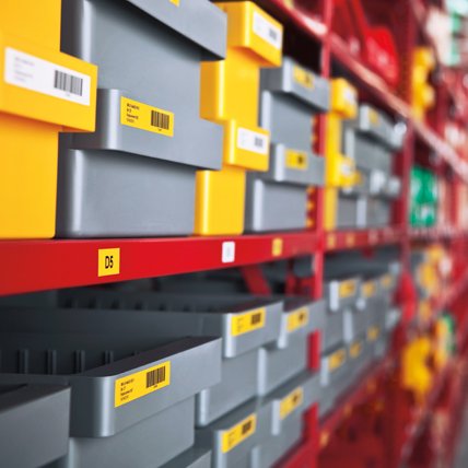 Rows of plastic bins with white and yellow barcode labels.