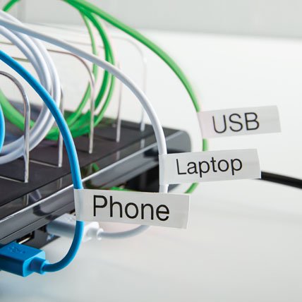 Labeled cables plugged into an electronic device.