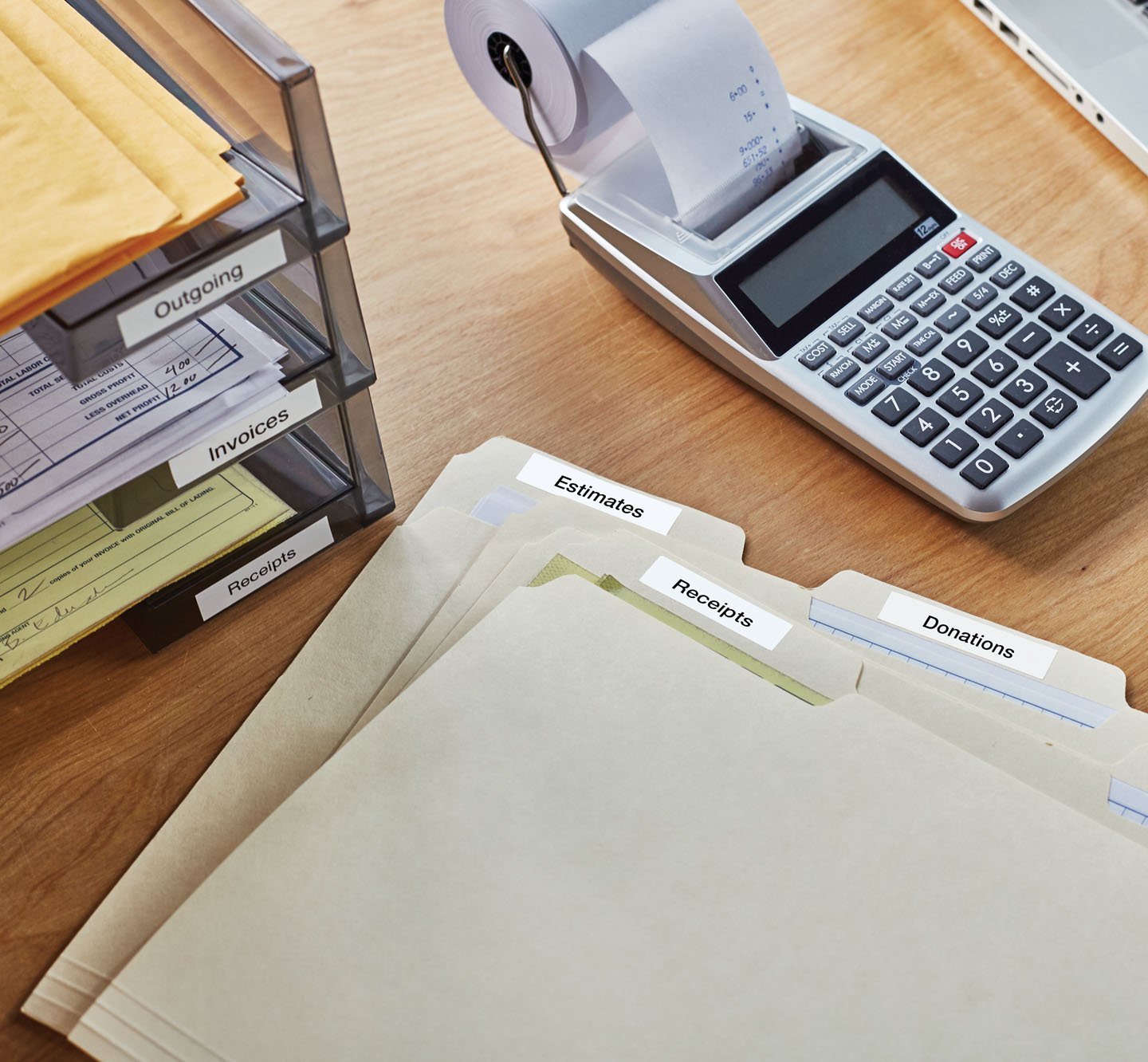 Labeled files and a labeled file organizer on a desk.