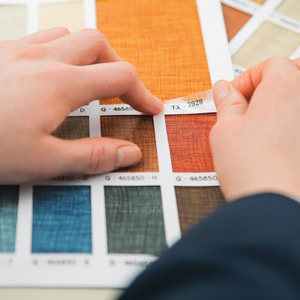 Hands adding labels to color swatches.