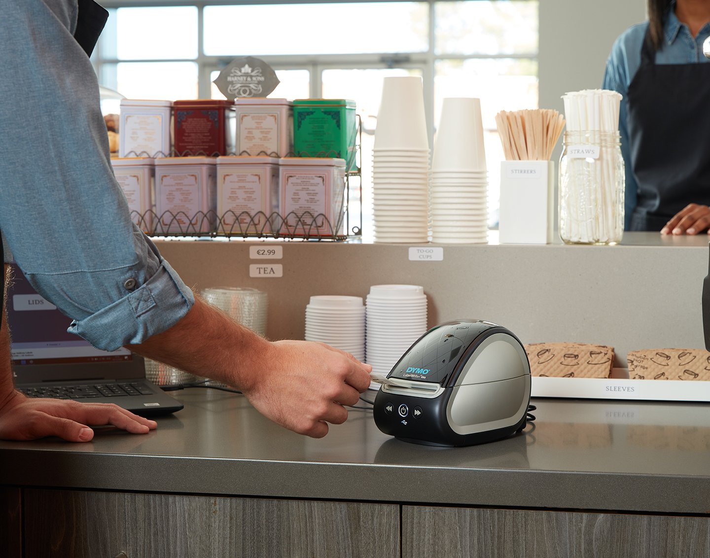 A label writer printing a label on a countertop.