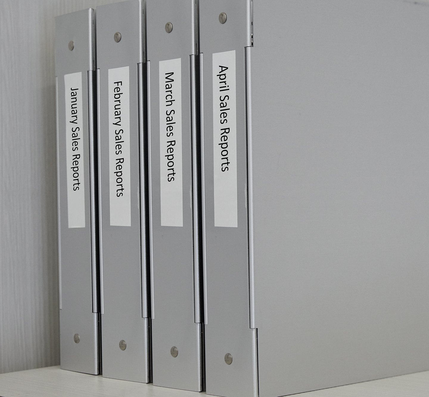 A row of labeled binders.
