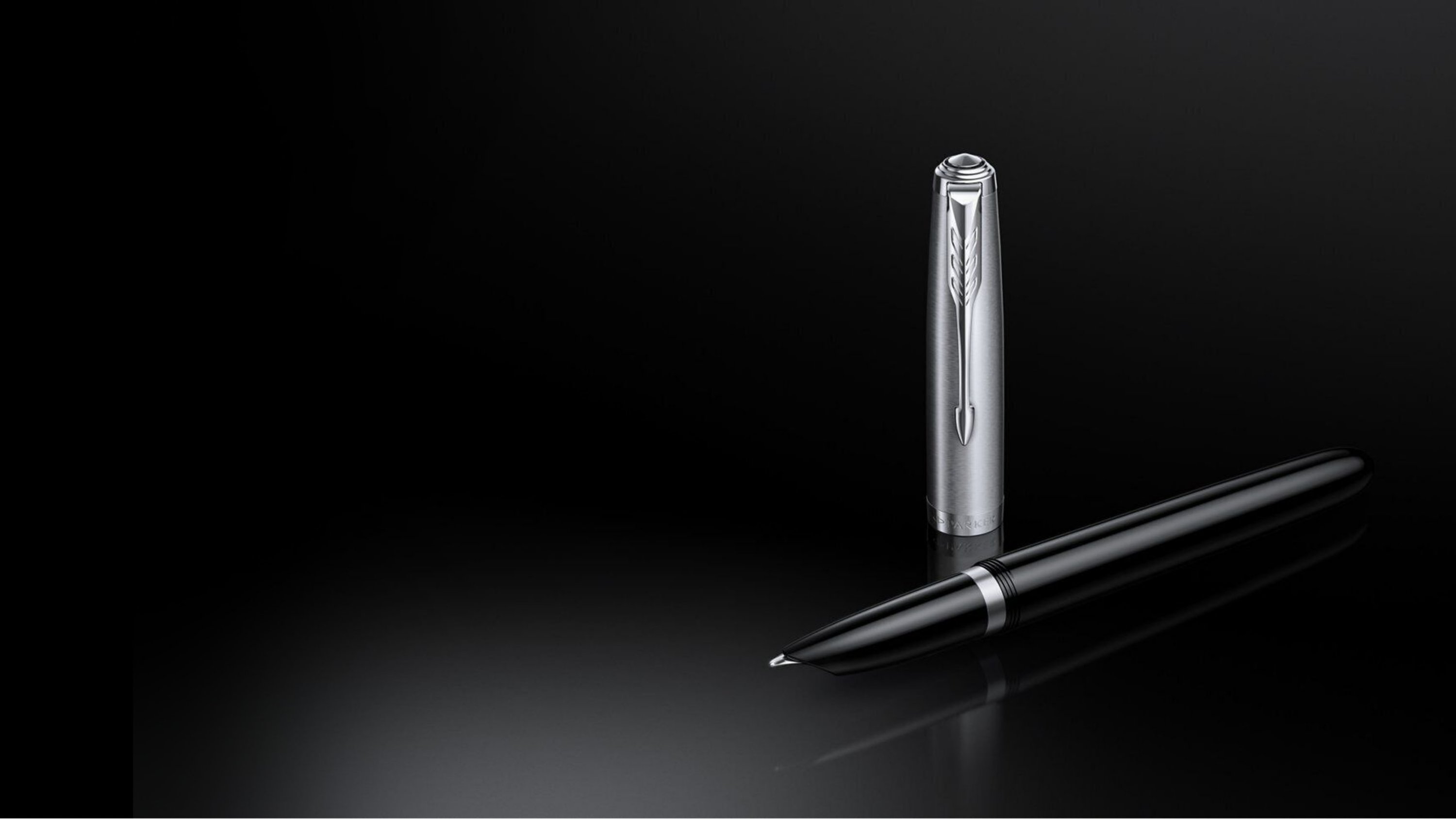 A Parker 51 black resin with chrome trim fountain pen under a spotlight.