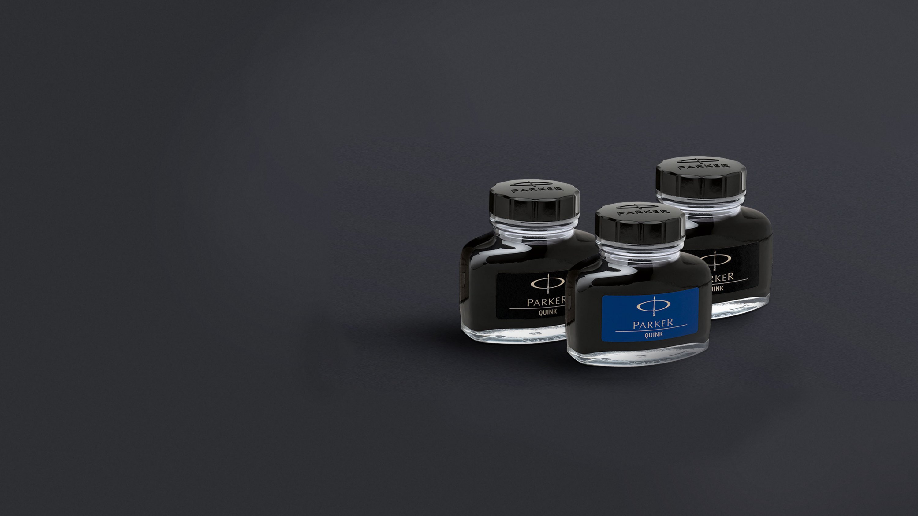 Three closed bottles of ink.
